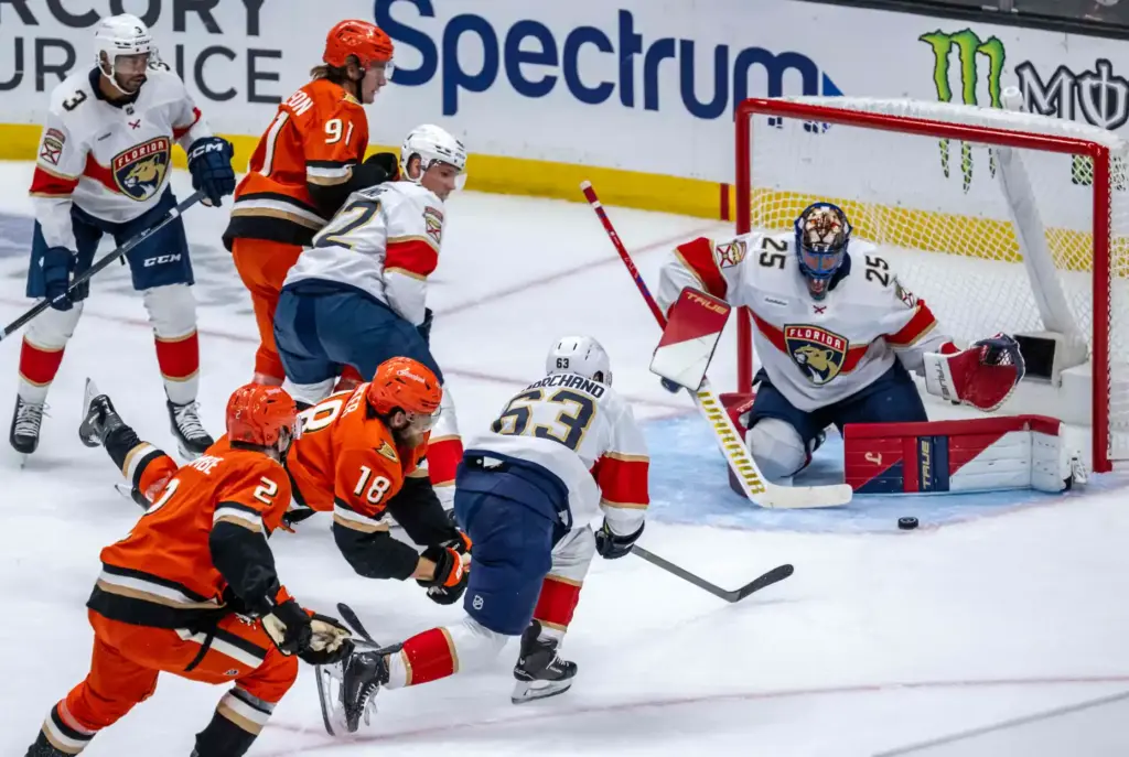 The Ducksâ A.J. Greer (18) dives on the ice as...