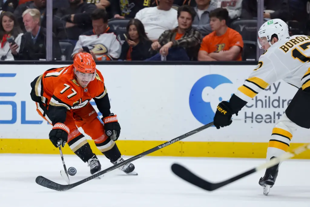 Ducks right wing Frank Vatrano, left, and Boston Bruins defenseman...