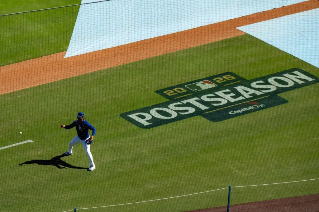 Dodgers shortstop Mookie Betts goes through fielding drills before Game...