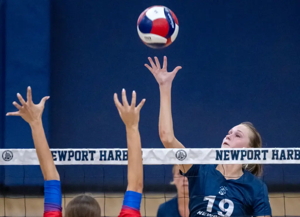 Newport Harbor outside hitter Piper Coady (19) tips the ball...