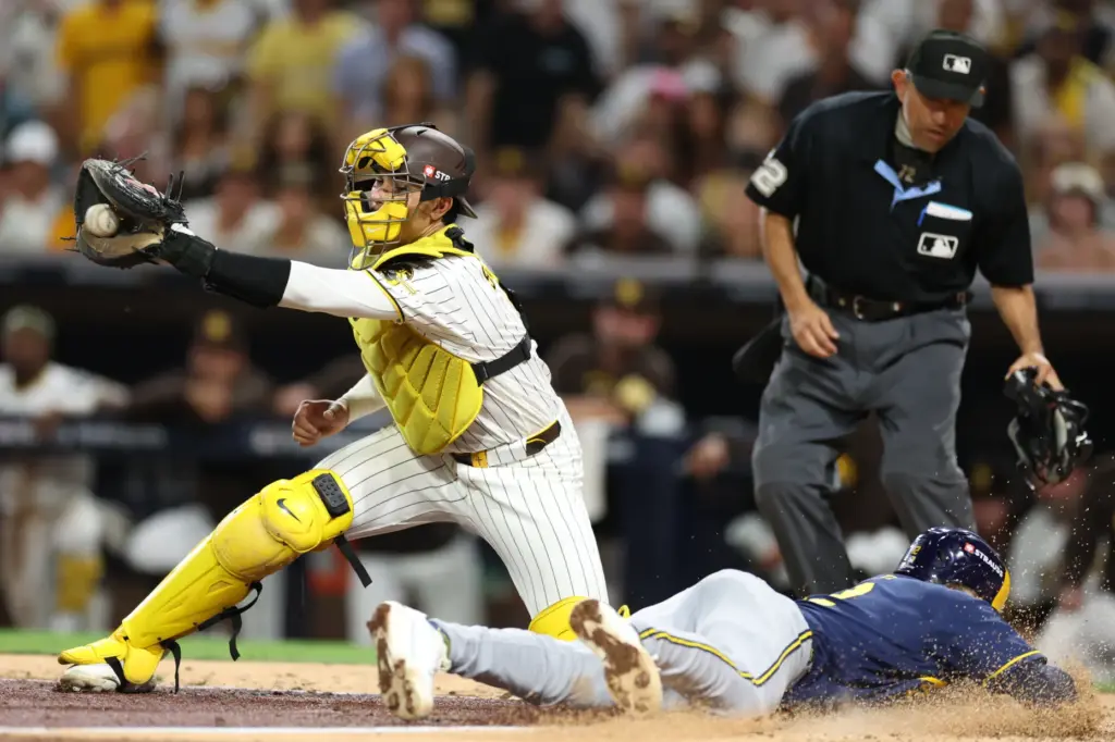 The Milwaukee Brewers’ Cooper Pratt scores past San Diego Padres...