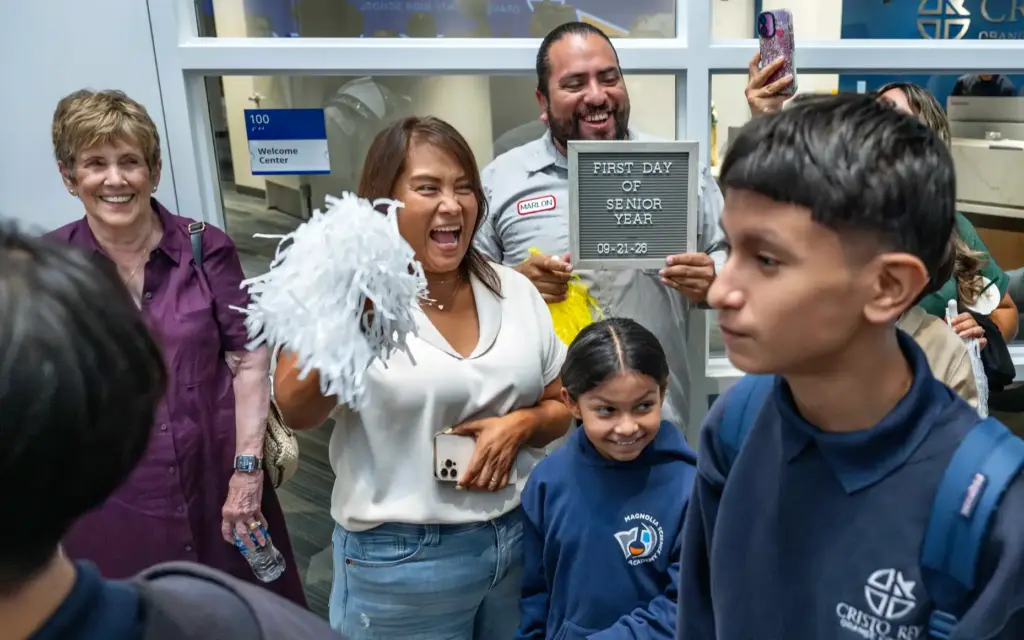 Marlon Duenas holds a sign celebrating his daughter Emmily’s first...