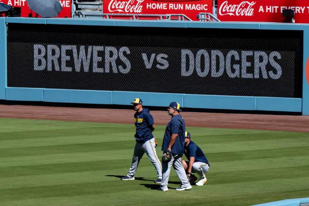 Milwaukee Brewers players and coaches take the field to work...