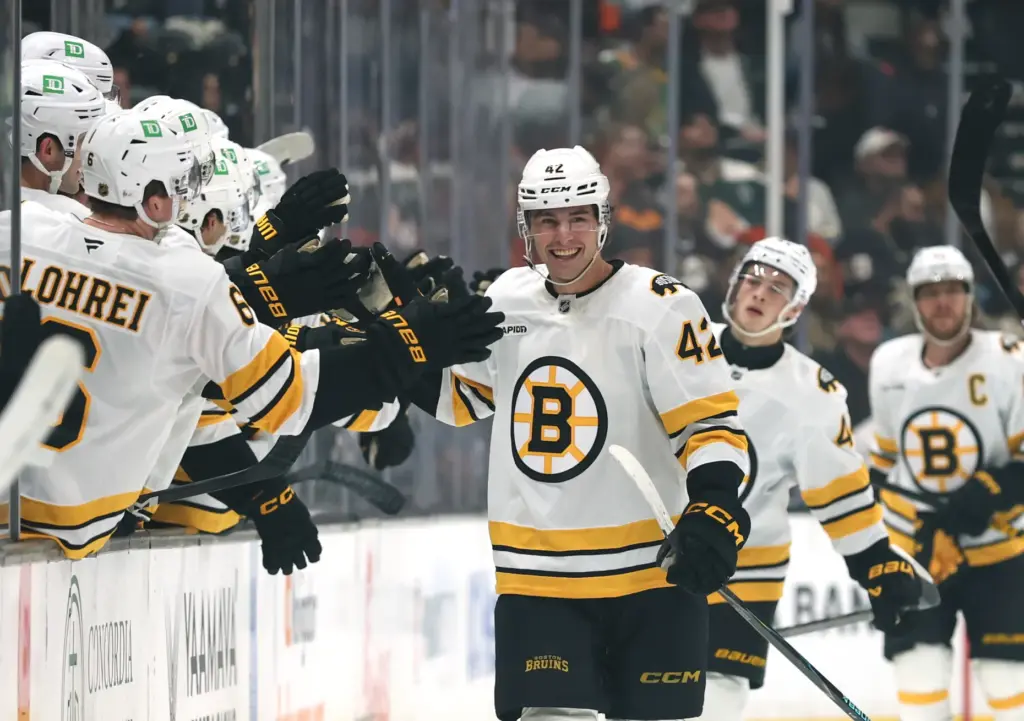 The Boston Bruins’ Frederic Brunet celebrates at the bench after...