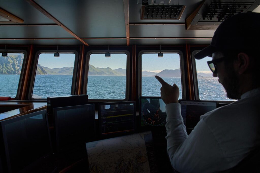 Maverick Blake, captain of the F/V Progress, monitors screens in...