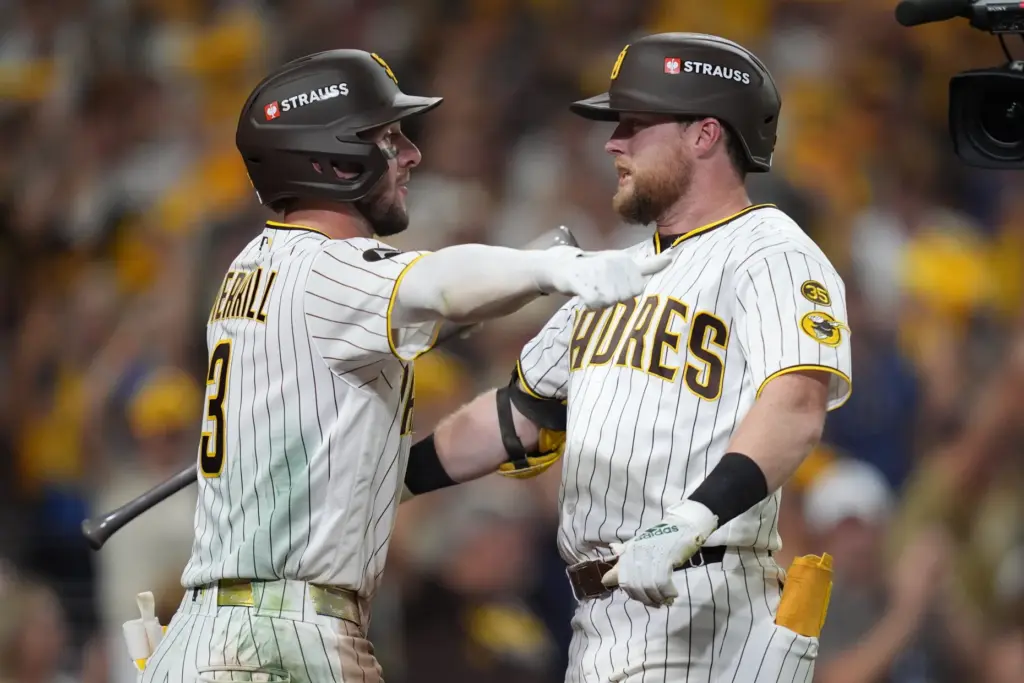 The San Diego Padres’ Jake Cronenworth, right, is congratulated by...