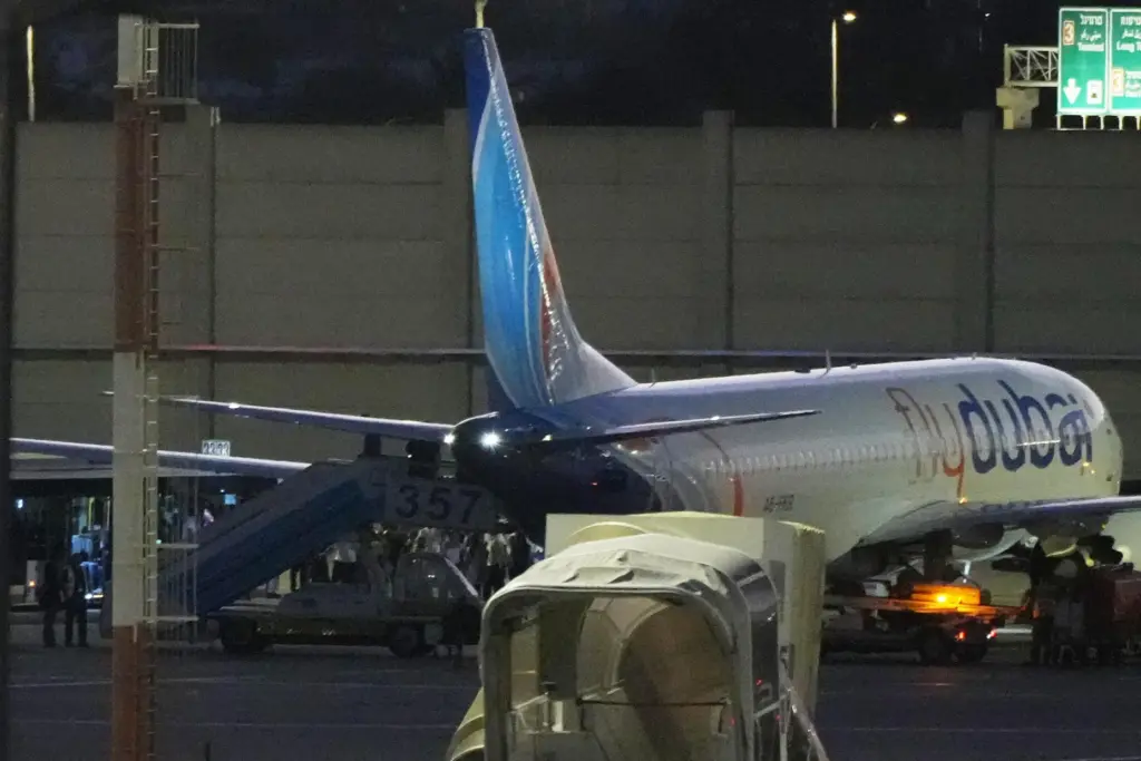 People disembark from a FlyDubai carrying Israeli passengers who had...