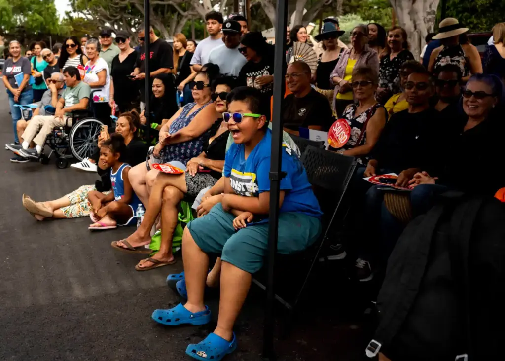 Community members cheer during the opening ceremony of the Memorial...