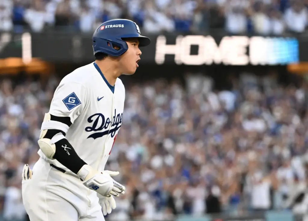 Dodgers star Shohei Ohtani celebrates as he begins to run...