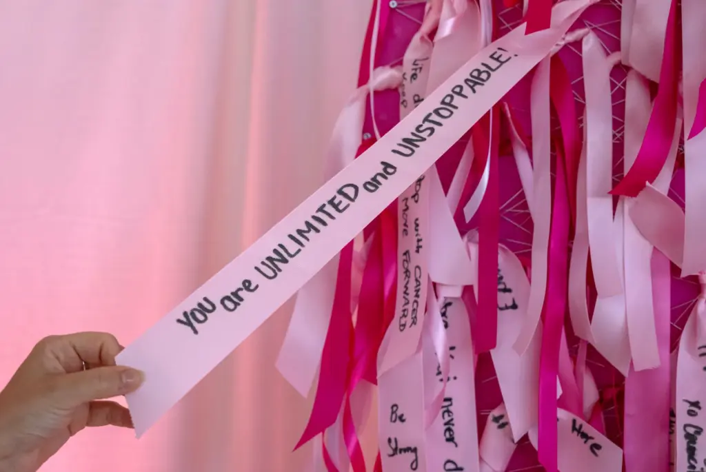 Survivors write messages on ribbons during the City of Hope...