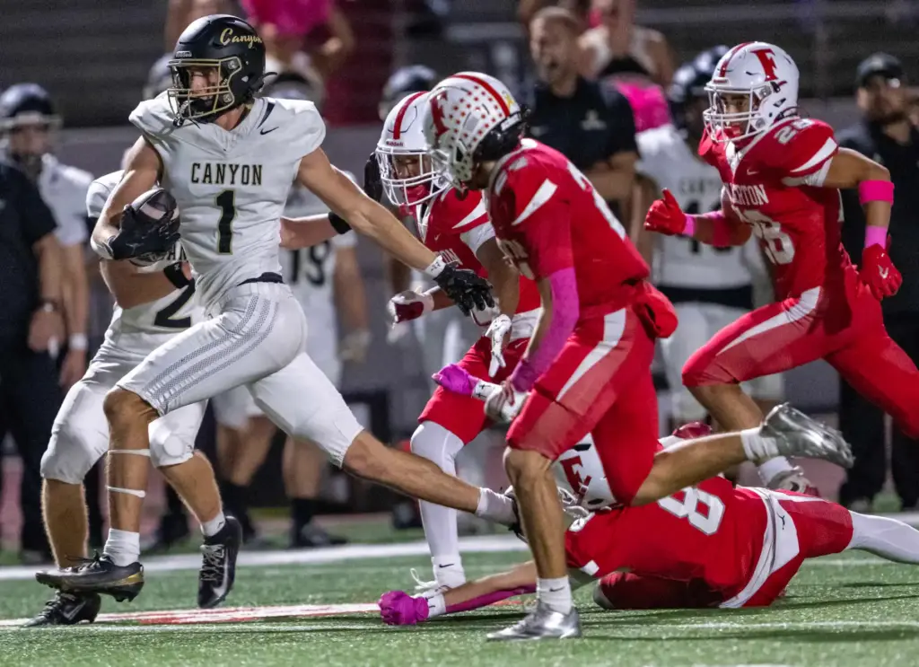Canyon wide receiver Zack Lachman (1) carries the ball on...
