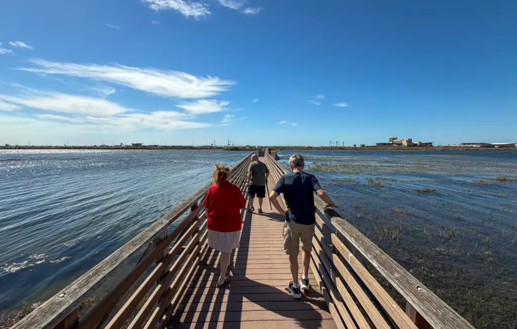Visitor cross the bridge at the Bolsa Chica Wetlands takes...
