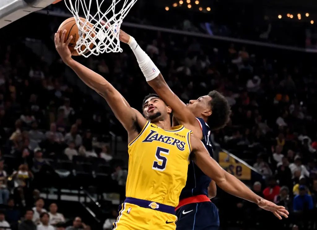 Lakers guard Quentin Grimes, left, is fouled by Clippers rookie...