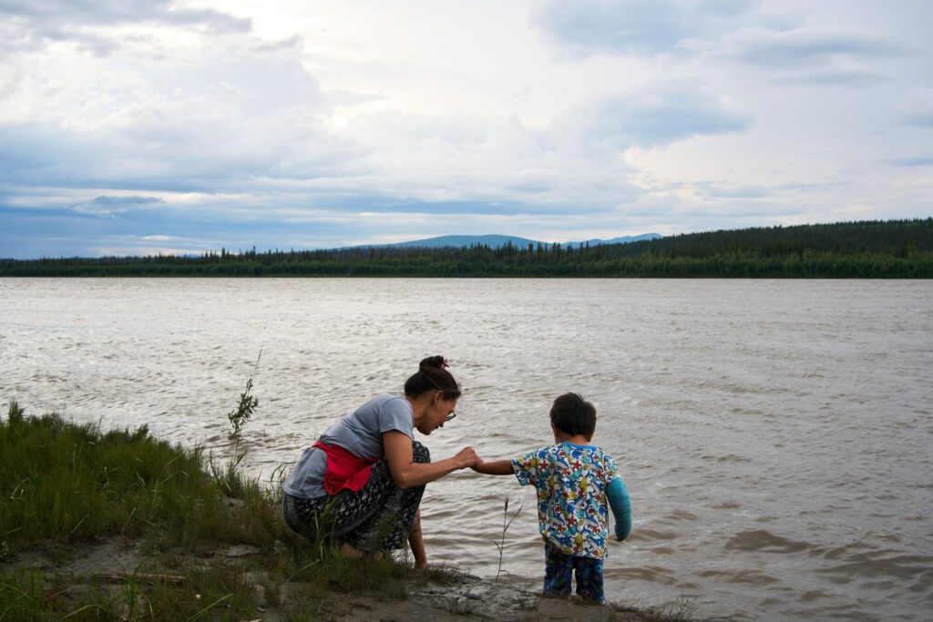 Brooke Woods and her son Lewis Thomas play in the...