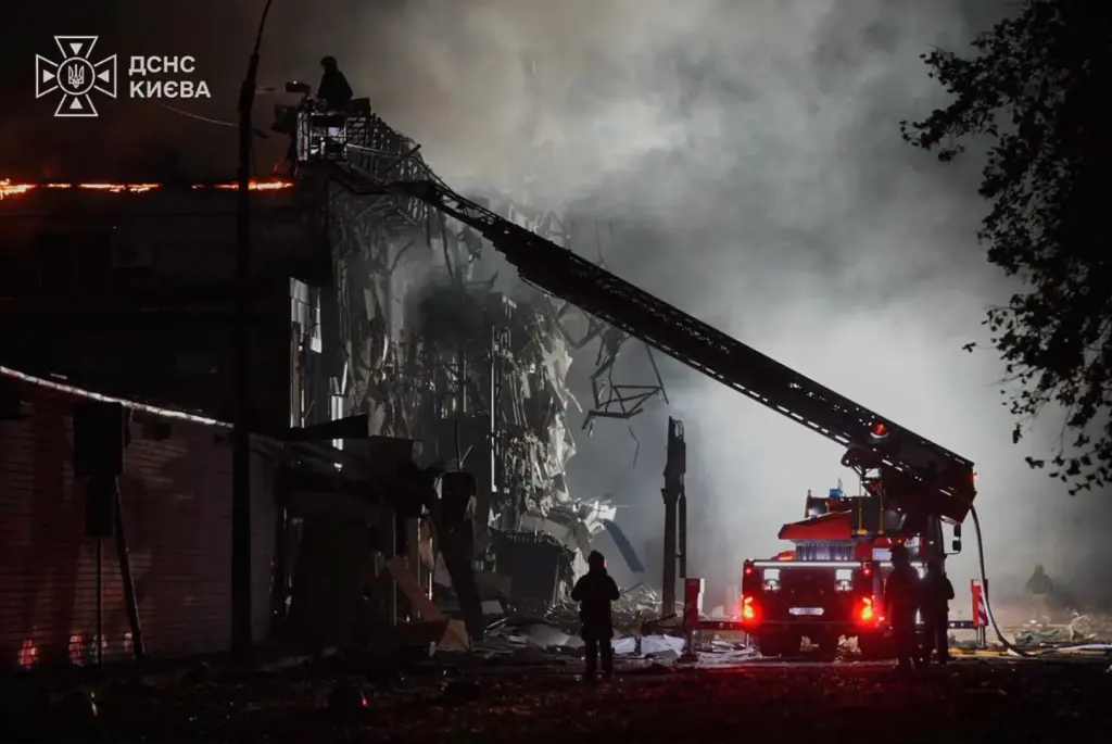 Emergency services personnel work to extinguish a fire following Russian missile attacks.