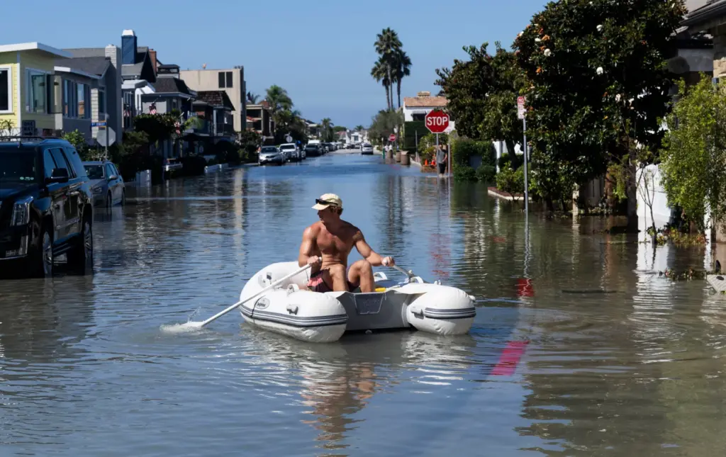 Jay Williams paddles an inflatable boat near his home on...
