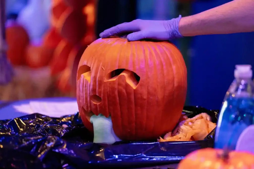 Foam spills from a carved pumpkinâs mouth during a Pumpkinology...