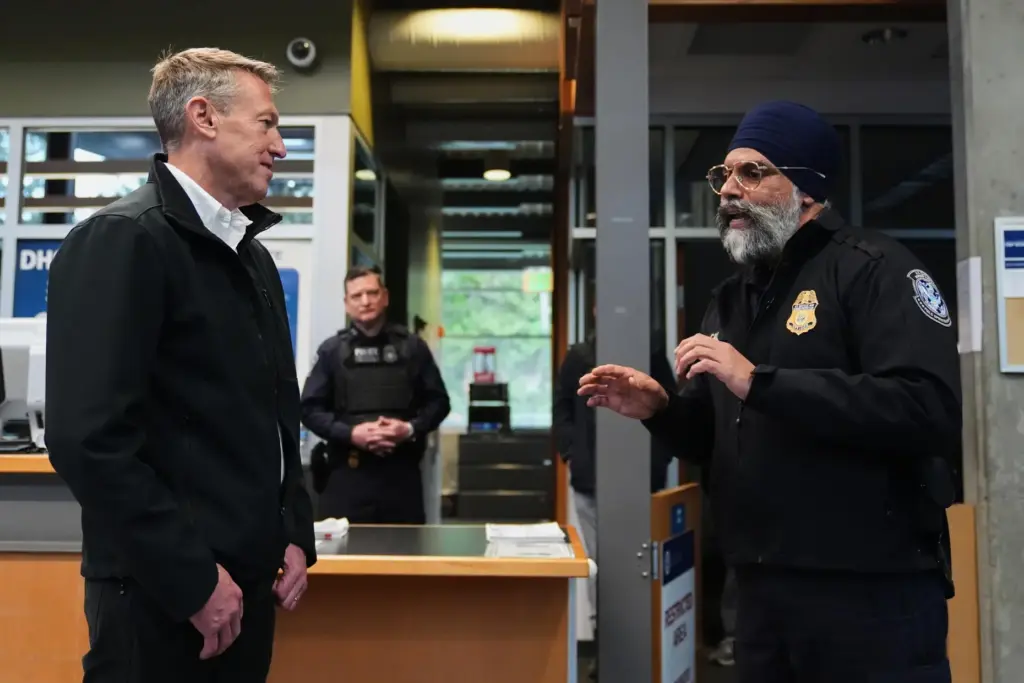 Commissioner of U.S. Customs and Border Protection Rodney Scott listens to Harmit S. Gill.