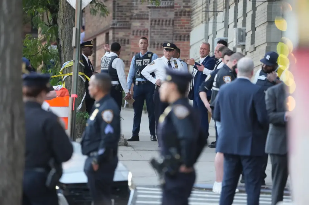 Law enforcement officers investigate after ICE agents shot and wounded...