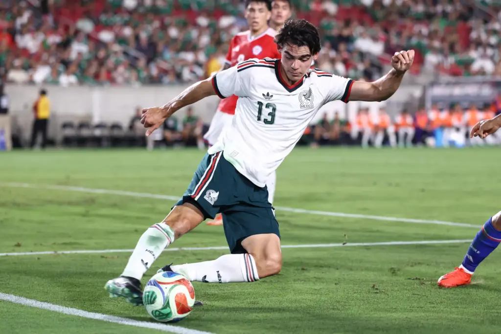 Mexico defender Dagoberto Espinoza attempts to recover the ball before...