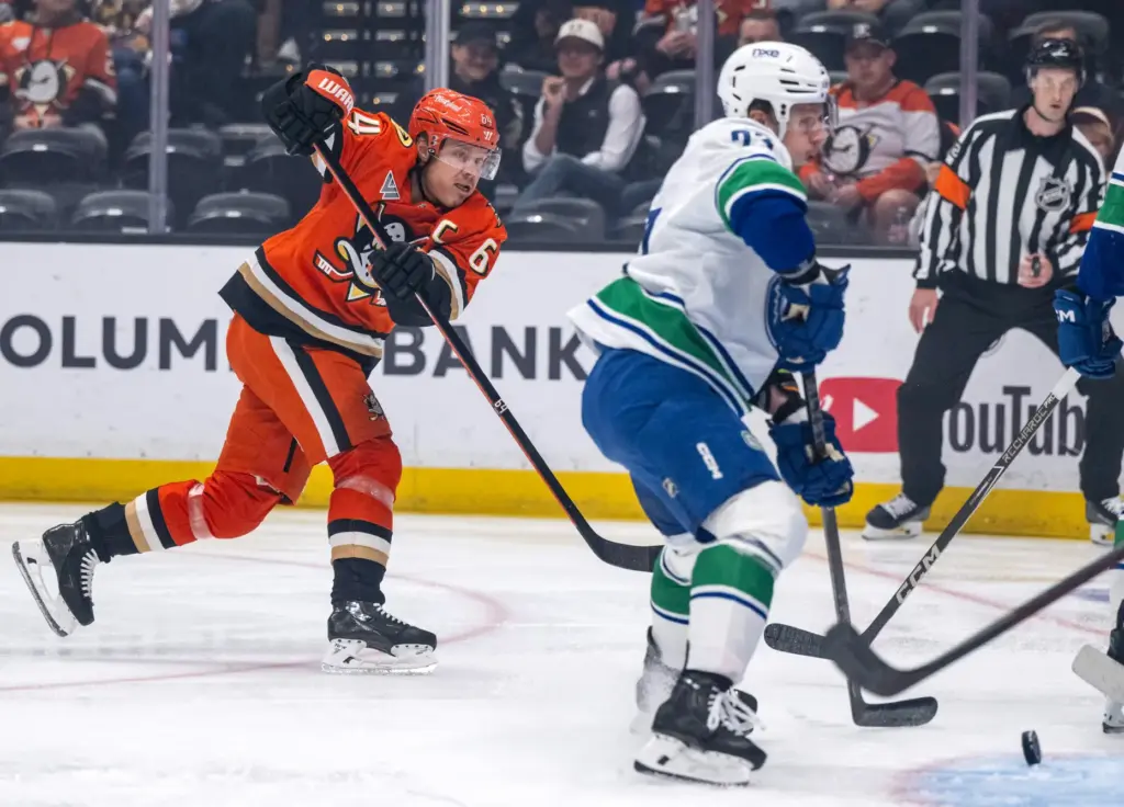 The Ducksâ Mikael Granlund, left, takes a shot on goal...