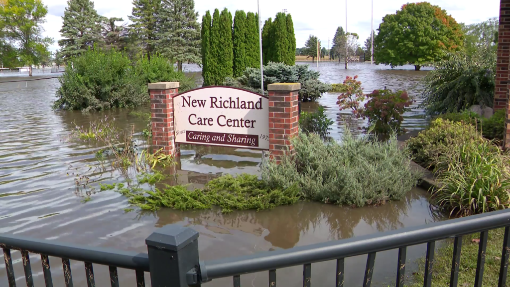 The New Richland Care Center sign amid flooding.