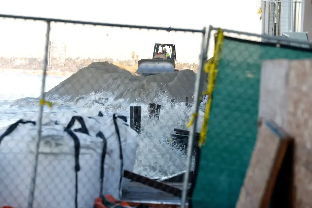 Work continues to reenforce the berm along the Peninsula on...