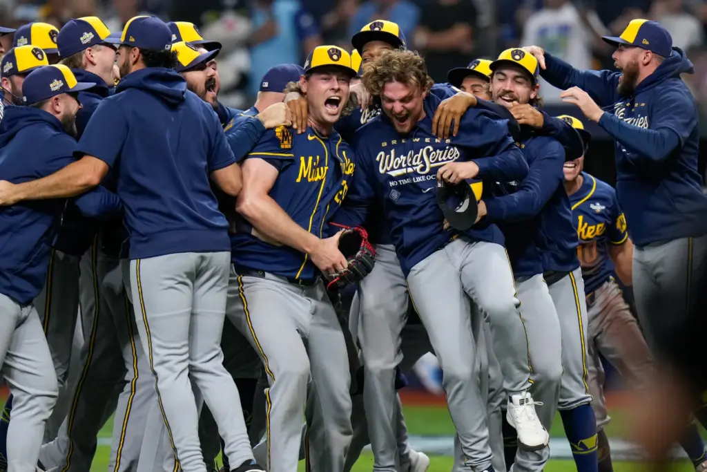 Milwaukee Brewers relief pitcher Trevor Megill, center, celebrates with teammates...