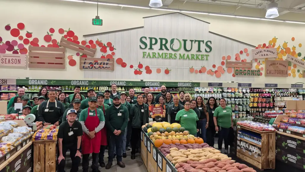 The new staff at Sprouts Farmers Market stands in the...
