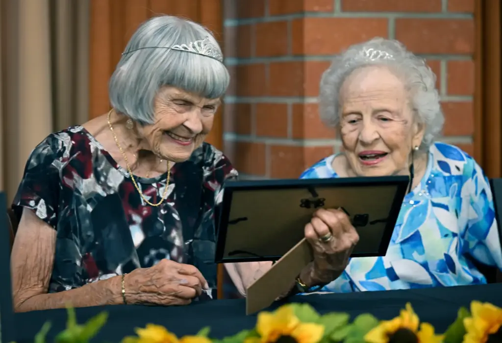 Marilyn Lindley, 101, left, and Soula Thomas, 102, smile as...