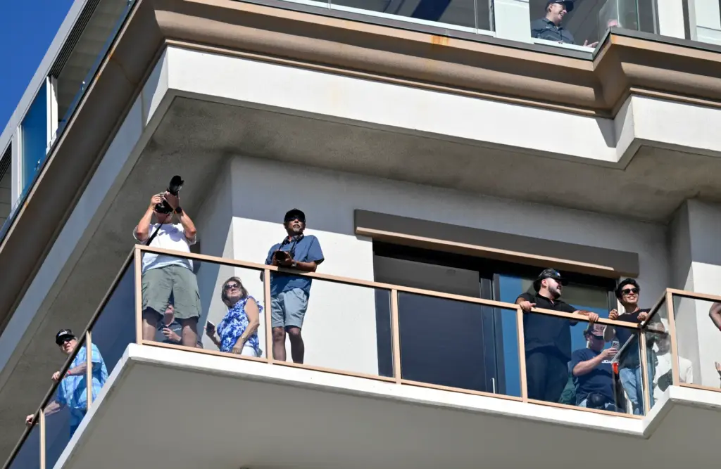 Guests from a nearby hotel watch the Pacific Airshow near...