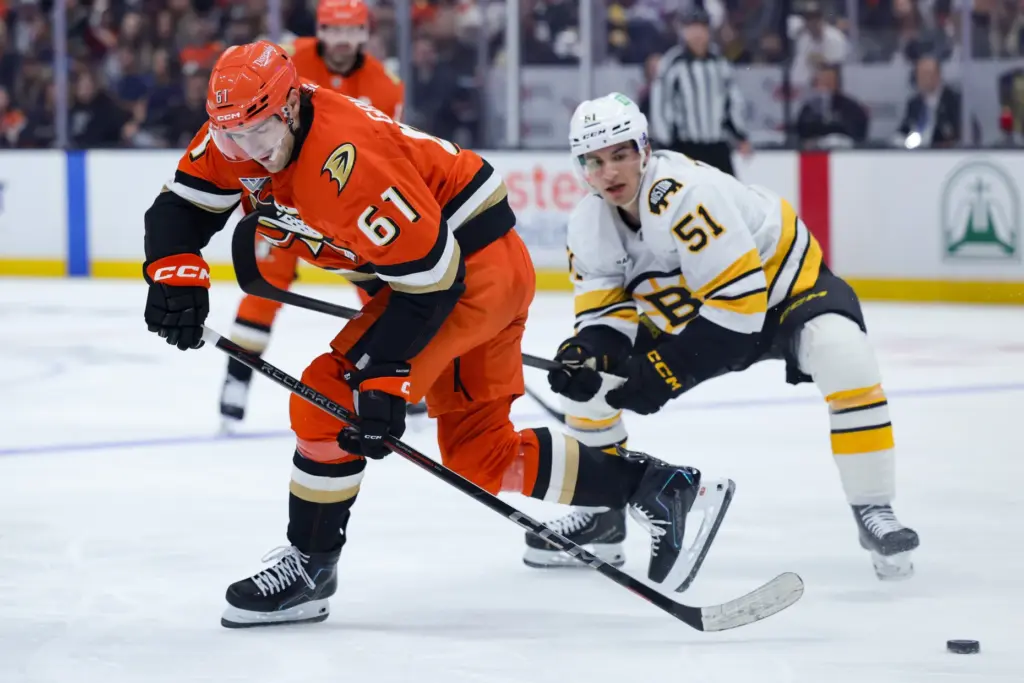 Ducks left wing Cutter Gauthier, left, moves the puck in...