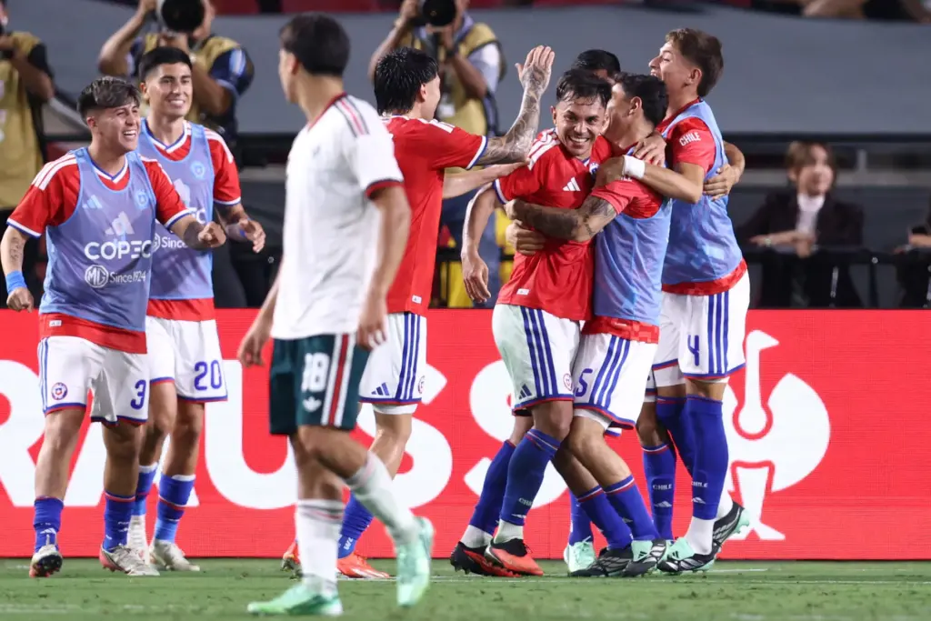 Chile midfielder Vicente Pizarro, third from right, celebrates with teammates...