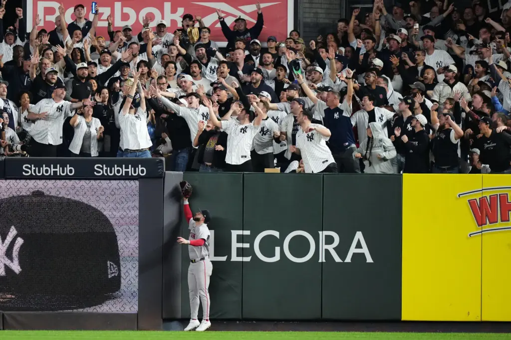 Boston Red Sox right fielder Wilyer Abreu watches as fans...