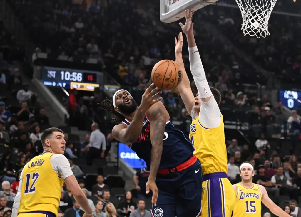 Clippers forward/center Isaiah Jackson passes the ball from the baseline...