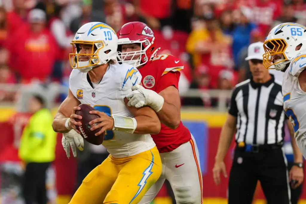 Chargers quarterback Justin Herbert (10) is sacked by Kansas City...