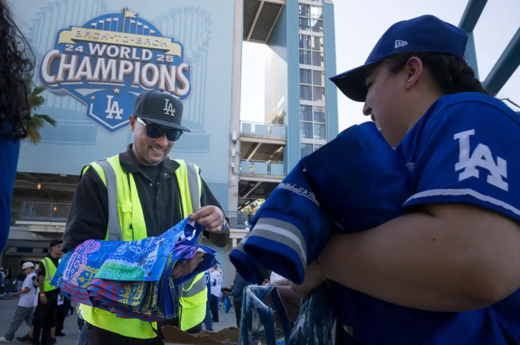 Dodgers fans receive rally towels as they arrive before Game...