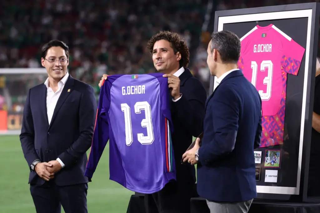 Former Mexico goalkeeper Guillermo Ochoa receives a commemorative jersey during...