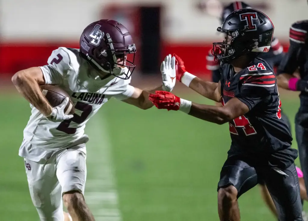 Laguna Beach wide receiver Brady Stringham (2) carries the ball...