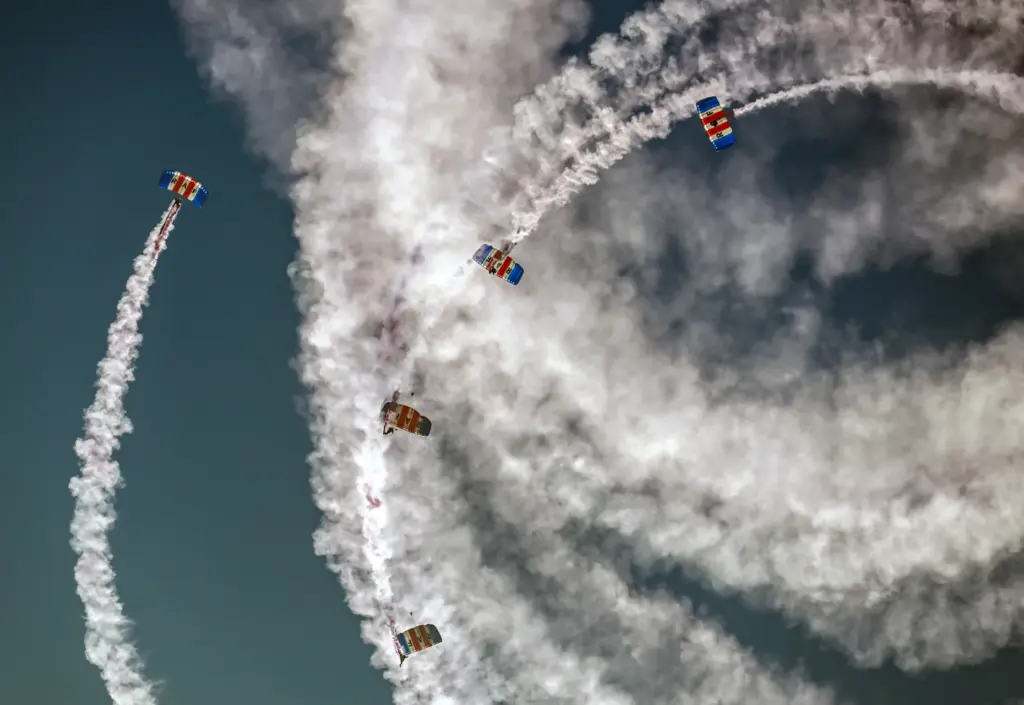 The Royal Air Force Falcons parachute team jump over the...