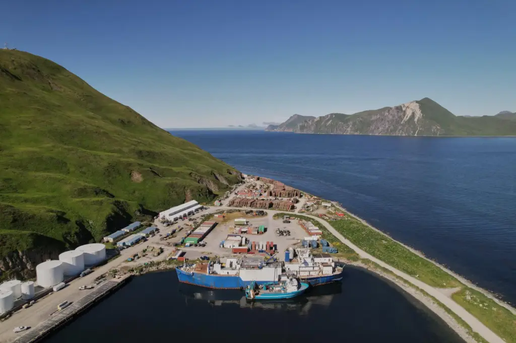 The F/V Progress delivers its catch to a processing vessel,...