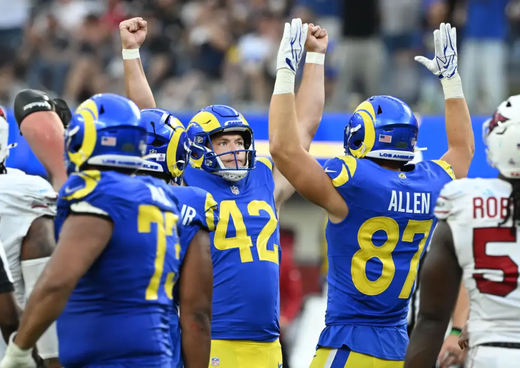 Rams punter Ethan Evans (42) kicks the go ahead extra...