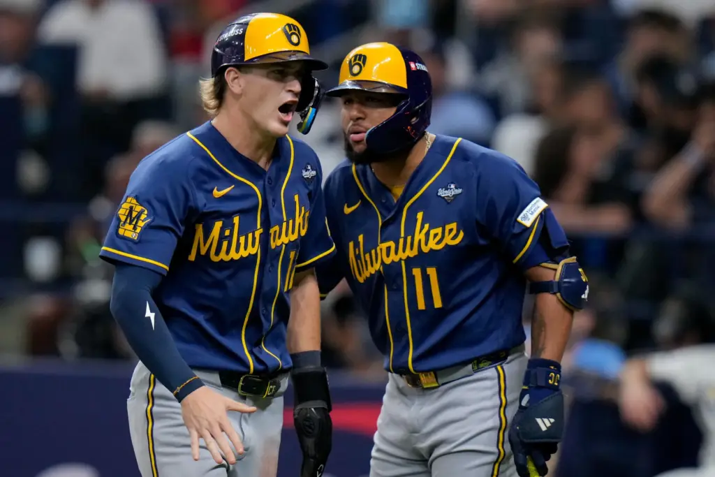 The Milwaukee Brewers’ Cooper Pratt celebrates after scoring with left...