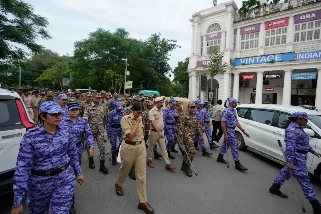 Security personnel patrol ahead of a tricolor (Indian flag) waving...