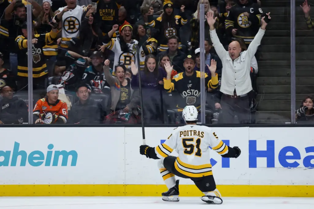 Boston Bruins center Matthew Poitras celebrates after scoring a goal...