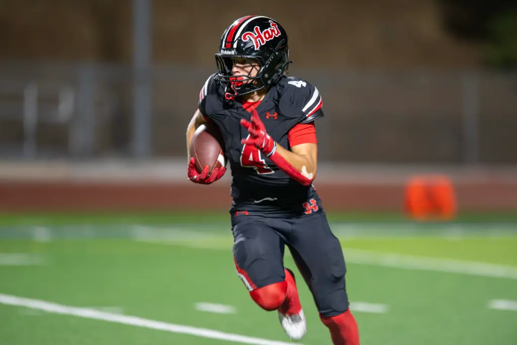 Hart High School’s Matix Frithsmith (4) carries the ball for...