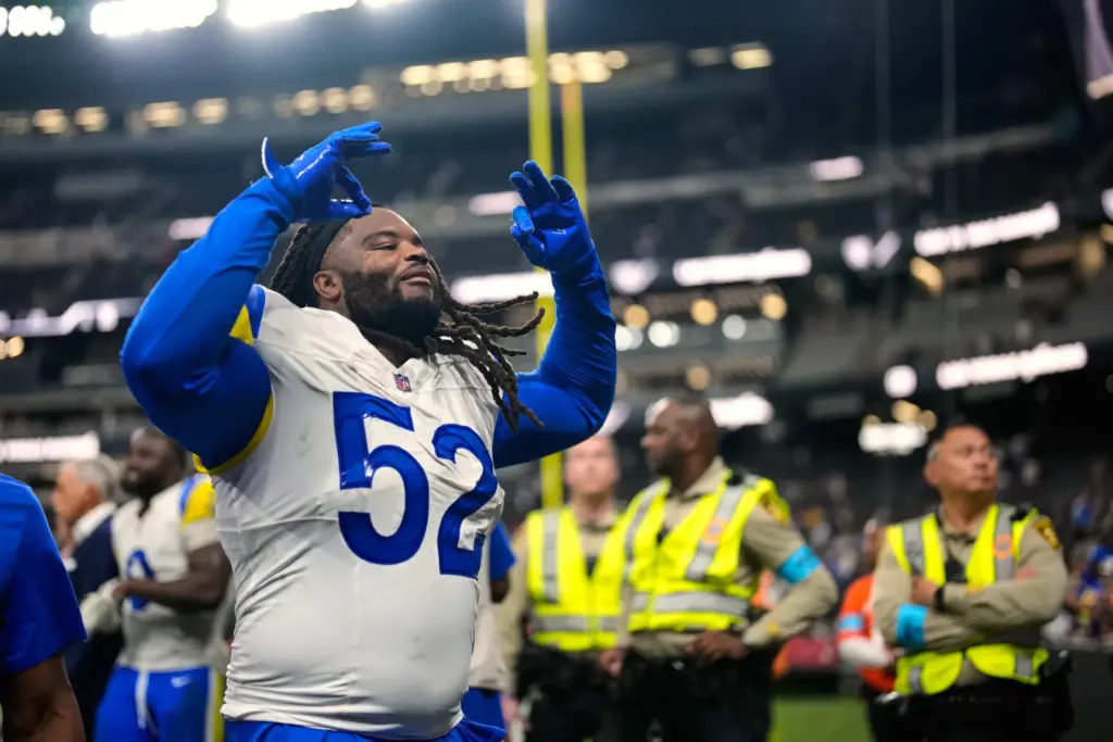 Rams defensive tackle Larrell Murchison gestures while running off the...