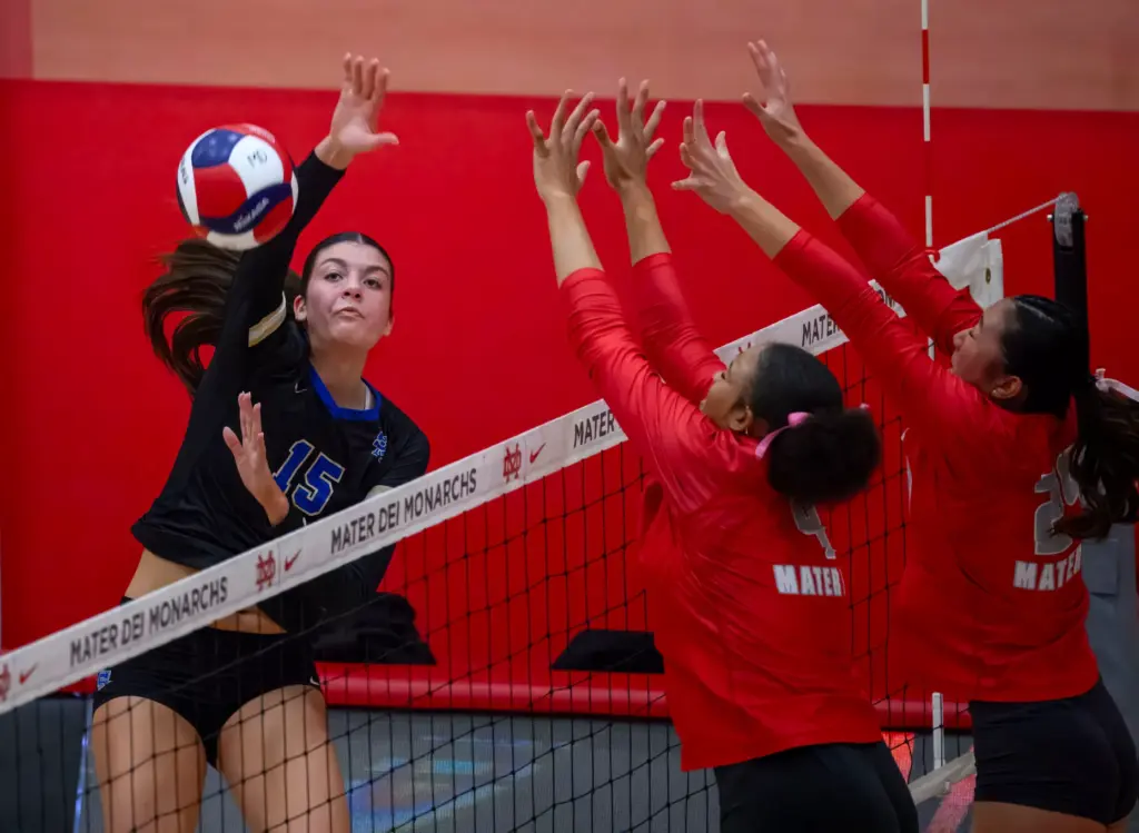 Santa Margarita’s Ireland Real, left, hits the ball over the...