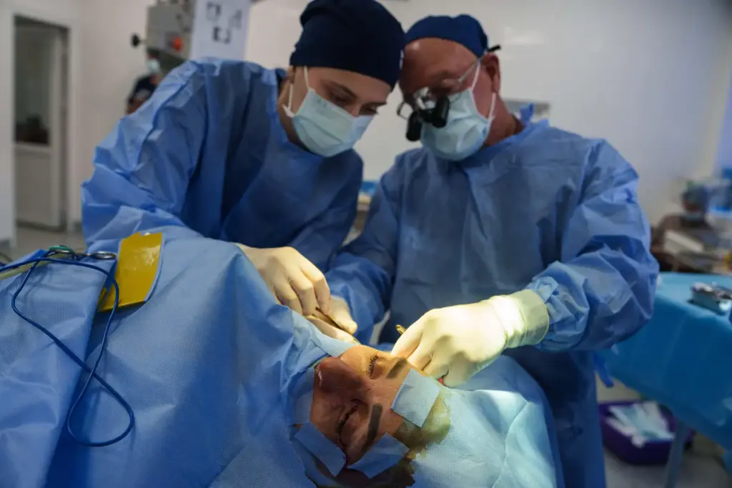 U.S. surgeon Stuart Seiff and a Ukrainian colleague perform a surgical operation on a wounded soldier's eye.