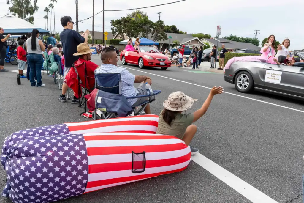Emma Banuelos, 11, waves to friends riding in the Miss...